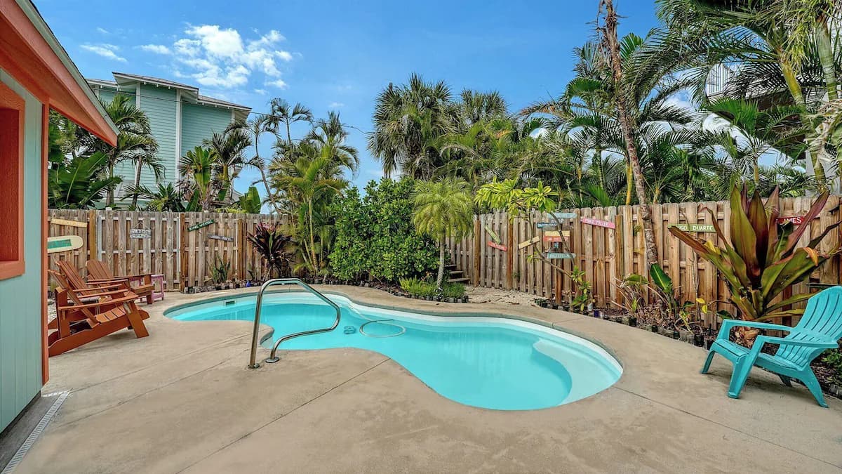 The pool and patio in the tropical backyard