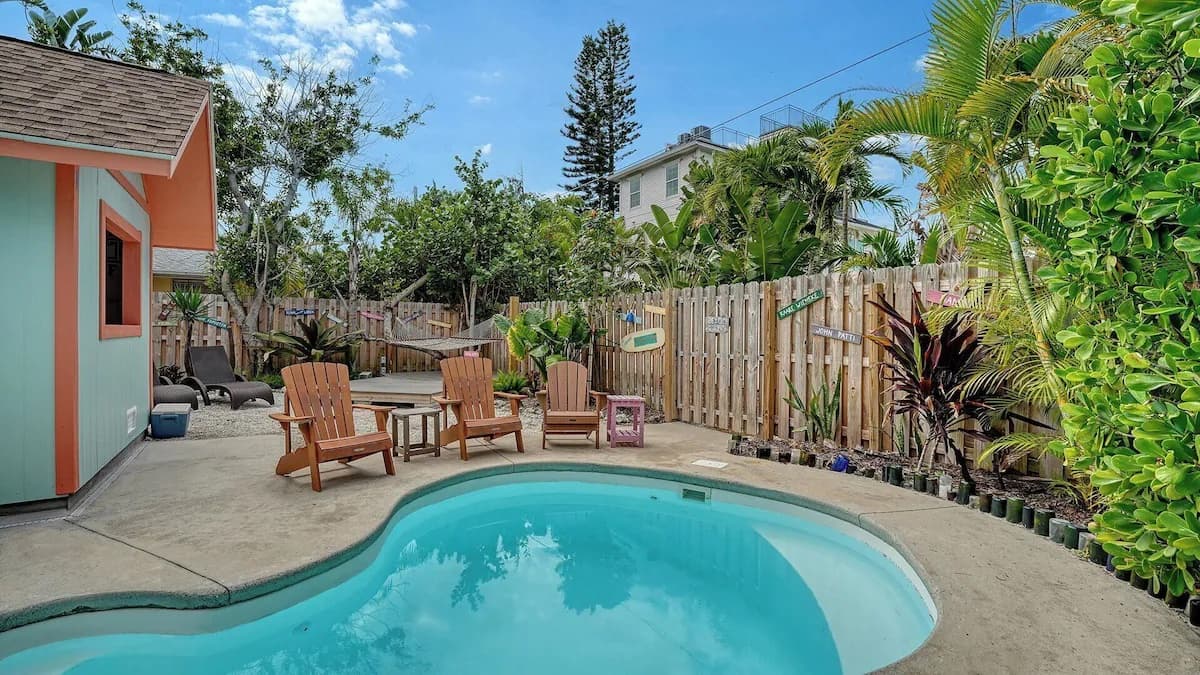 The private pool, patio and Adirondack chairs in the backyard