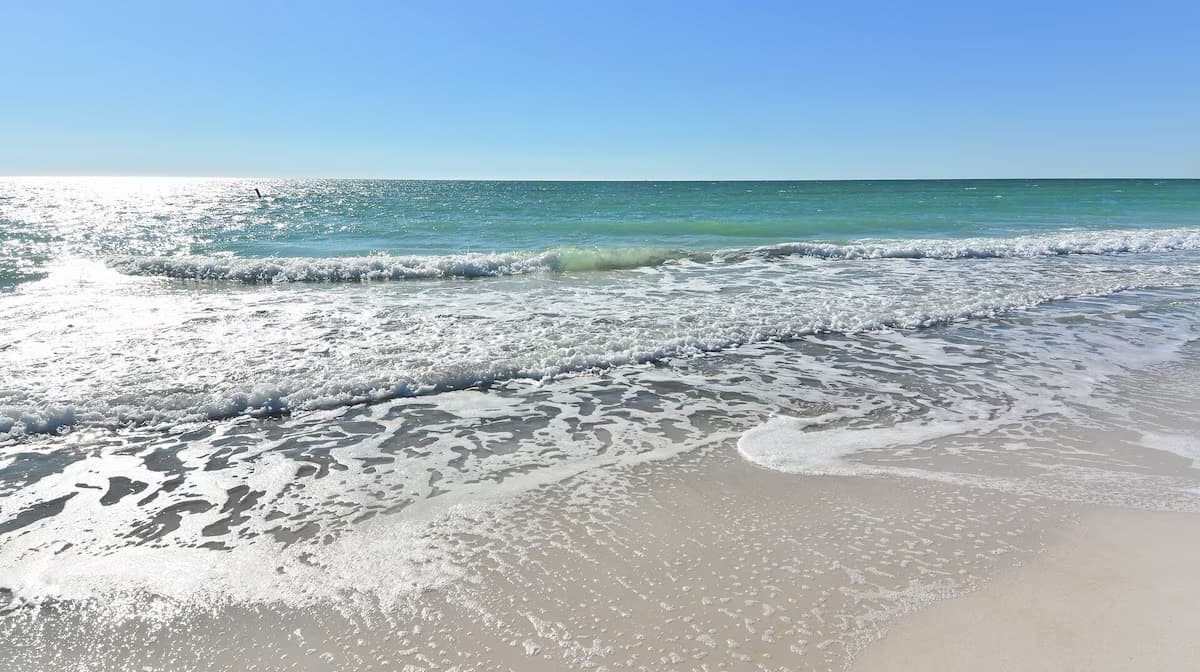 Gulf waves rolling onto white sand on Anna Maria Island